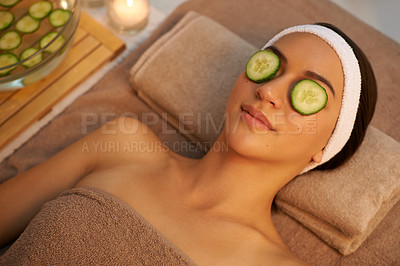 Buy stock photo Top view, skincare and woman with cucumber on eyes at massage table in spa for peace, relax or wellness. Mask, above and person with vegetable on face for natural beauty or healthy organic treatment