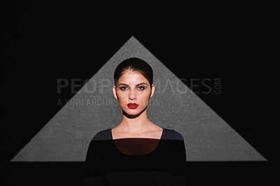 Buy stock photo Portrait, shape and woman with light of triangle, art and isolated on gray background. Female person, lady and spotlight on face for cosmetics, beauty and makeup by mockup on studio backdrop