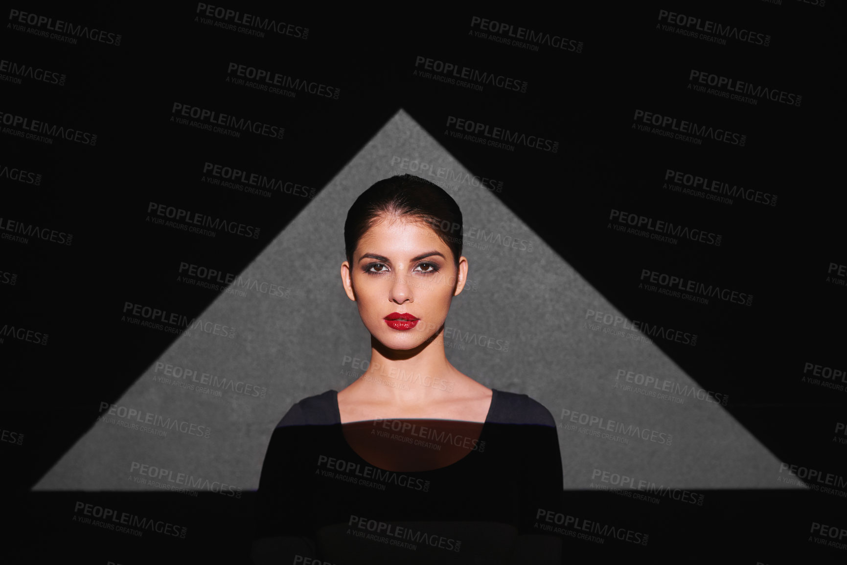 Buy stock photo Portrait, shape and woman with light of triangle, art and isolated on gray background. Female person, lady and spotlight on face for cosmetics, beauty and makeup by mockup on studio backdrop