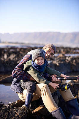 Buy stock photo Father, fishing and portrait of young boy, seaside and bonding for activity by ocean. Sea, rod and learning how to fish for childhood development, winter and hobby together while on ocean vacation