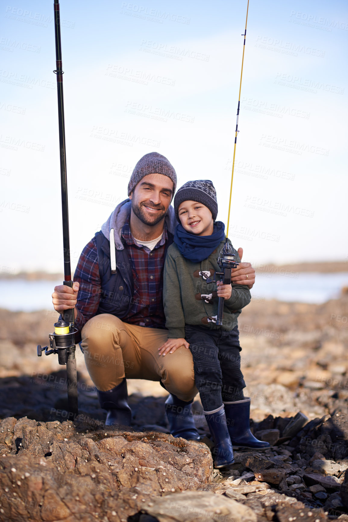 Buy stock photo Portrait, dad and son with nature, smile and happiness for bonding on break. Child, water and ocean with rocks, adventure and vacation on fishing trip with childhood memories and parent fun at sea