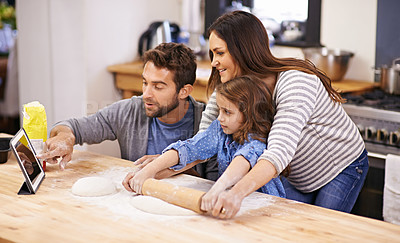Buy stock photo Family, learning and cooking in kitchen with tablet for recipe, guide and parents with child in home. Baking, mom and dad helping girl with rolling pin and talking about pizza, dinner or meal prep