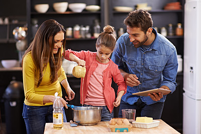 Buy stock photo Family, kitchen and tablet for baking with care, recipe online with ingredients for cake or dessert with support and handmade. Mom, dad and child cooking together with love for bonding or teaching