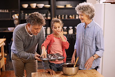 Buy stock photo Girl, grandparents and baking with cupcakes, kitchen and bonding together. Mature couple, smile and child with happiness, love and learning at home with grandmother for childhood memories and family