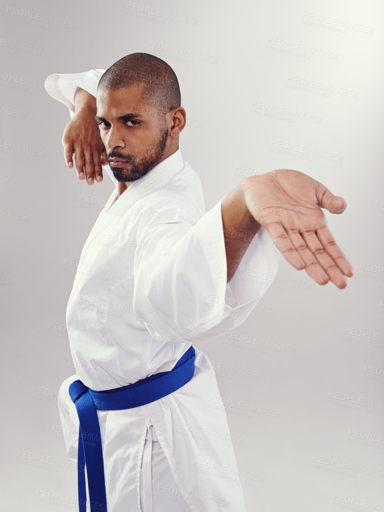 Buy stock photo Studio, karate and black man with technique for martial arts with hand strike, shuto uchi and training. White background, adult and African male person with healthy body for movement and disciple