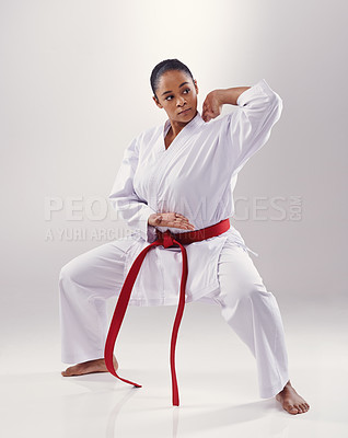 Buy stock photo Woman, training and karate fighter in studio, fitness and martial arts on white background. Black person, athlete and red belt for taekwondo, discipline and warrior ready for self defense or battle