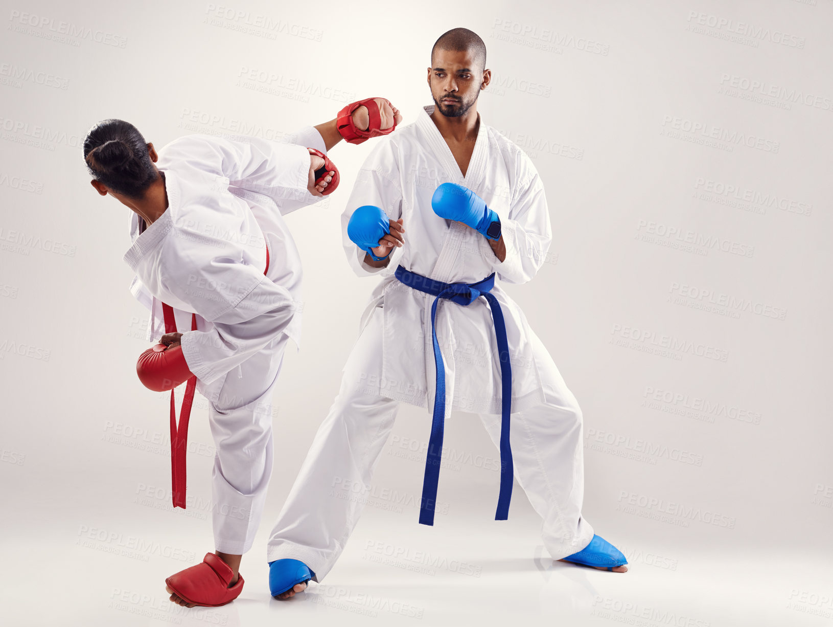 Buy stock photo People, karate and kick with training in studio on white background to fight or practice for competition. Mma, sport and kick with glove for fitness, commitment and confidence with focus as fighters 
