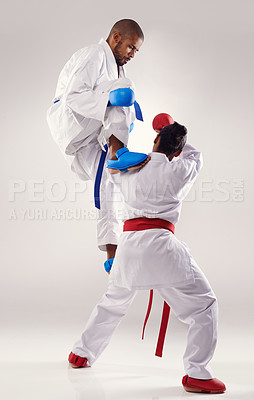 Buy stock photo People, karate and attack with training in studio on white background to fight or practice for competition. Mma, sport and kick or respect with fitness, commitment and confidence as fighter 