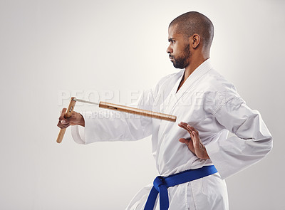 Buy stock photo Man, karate and belt for martial art, sport and strength for fight and strong for technique and power in studio. African person and focus with tool for train, defend and recreation for active  