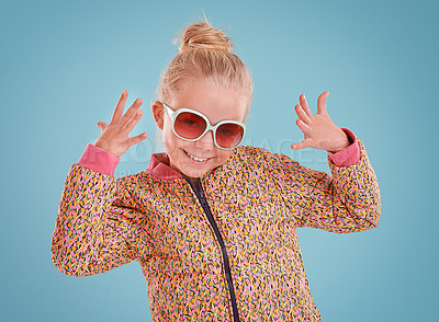 Buy stock photo Little girl, portrait and fashion with sunglasses in studio for trendy, cool and funky style with confidence. Cute child, smile and happy in blue background, young kid and retro clothes with glasses