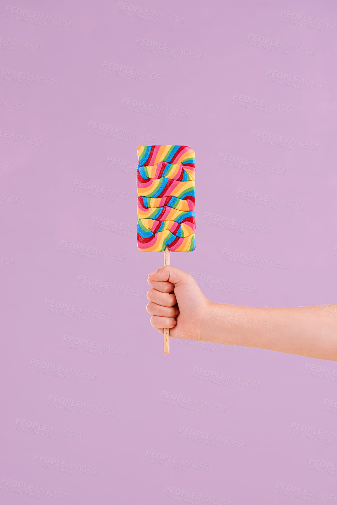 Buy stock photo Hand, lollipop and candy in studio for dessert sweets on purple background for carnival snack, hungry or mockup space. Fingers, stick and treats for party food or sugar eating, birthday or unhealthy
