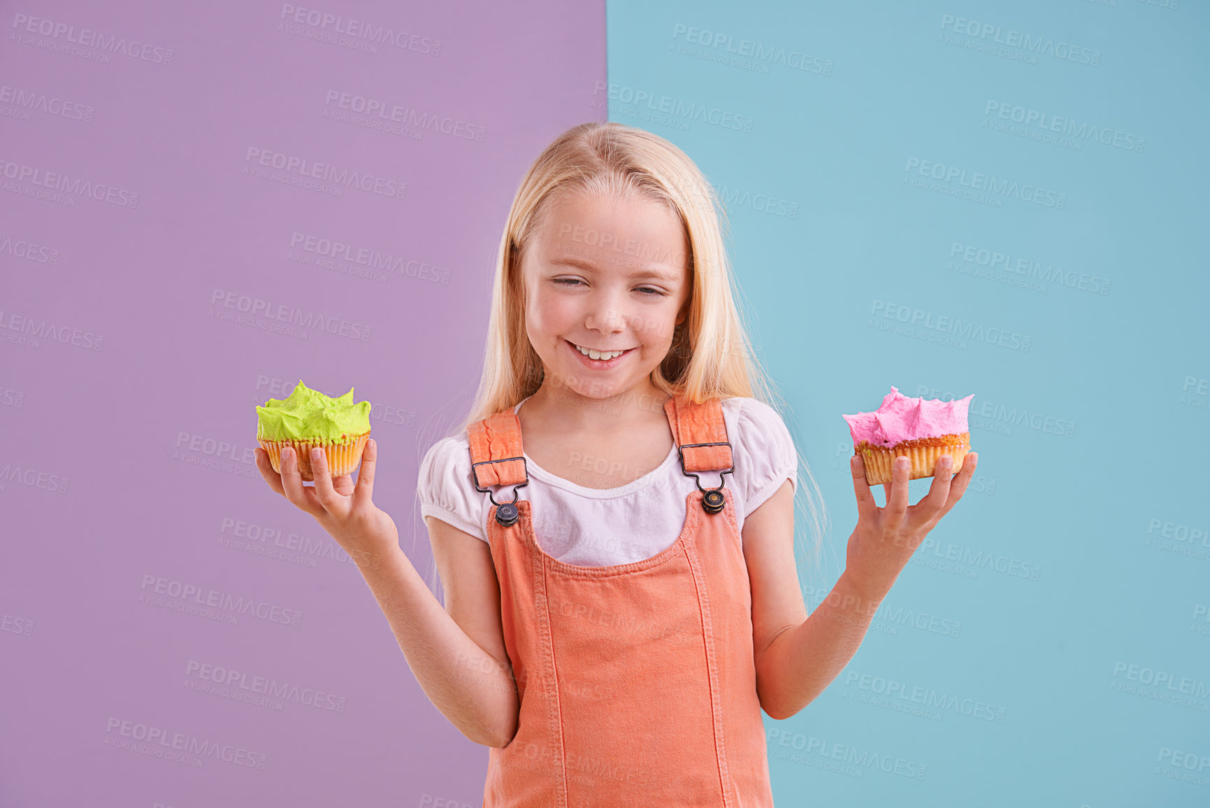 Buy stock photo Child, cupcake and portrait for colorblock in studio for dessert, pastry and icing for sugar, cake and frosting. Little girl or kid and smile for decide with green or pink for happy and delicious