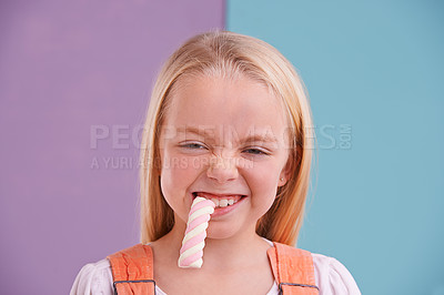 Buy stock photo Studio, girl and candy with marshmallow, dessert and hungry for snack and childhood. Child, sweets and yummy food for tasty, eating and happiness on vibrant split pastel pink and blue background