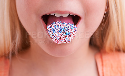 Buy stock photo Cropped closeup of a little girl with candy on her tongue