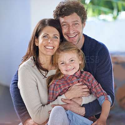 Buy stock photo Family hug in portrait, relax in backyard with mom and dad with kid with love and care outside house. Faces of happy people with smile, woman and man with girl child together at home outdoor