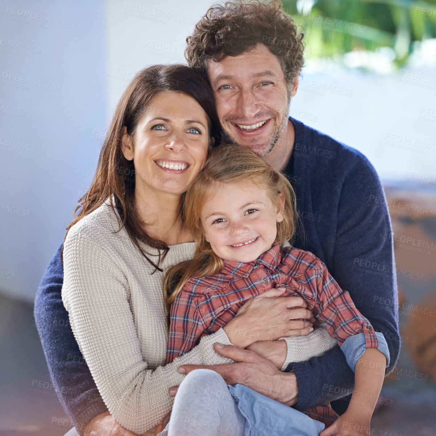 Buy stock photo Family hug in portrait, relax in backyard with mom and dad with kid with love and care outside house. Faces of happy people with smile, woman and man with girl child together at home outdoor