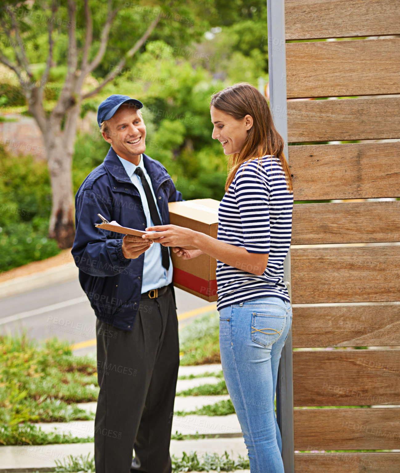 Buy stock photo Parcel, clipboard and deliveryman with woman at her home gate for ecommerce shipping package. Outdoor, order and courier driver with cardboard box with female person for signature at house entrance.