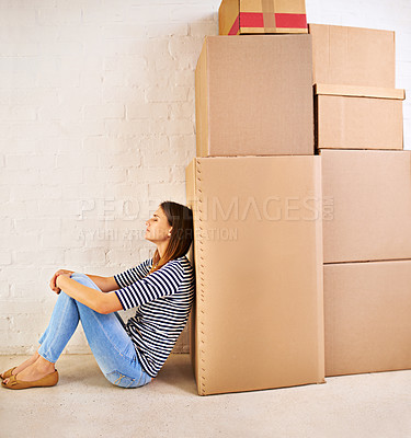 Buy stock photo Shot of an attractive young woman busy moving house