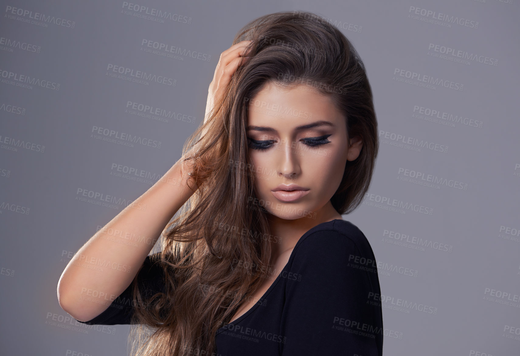 Buy stock photo Aesthetic, hair care and woman with beauty, texture and treatment on a grey studio background. Wellness, person and model with shampoo and keratin with makeup and cosmetics with shine and glowing