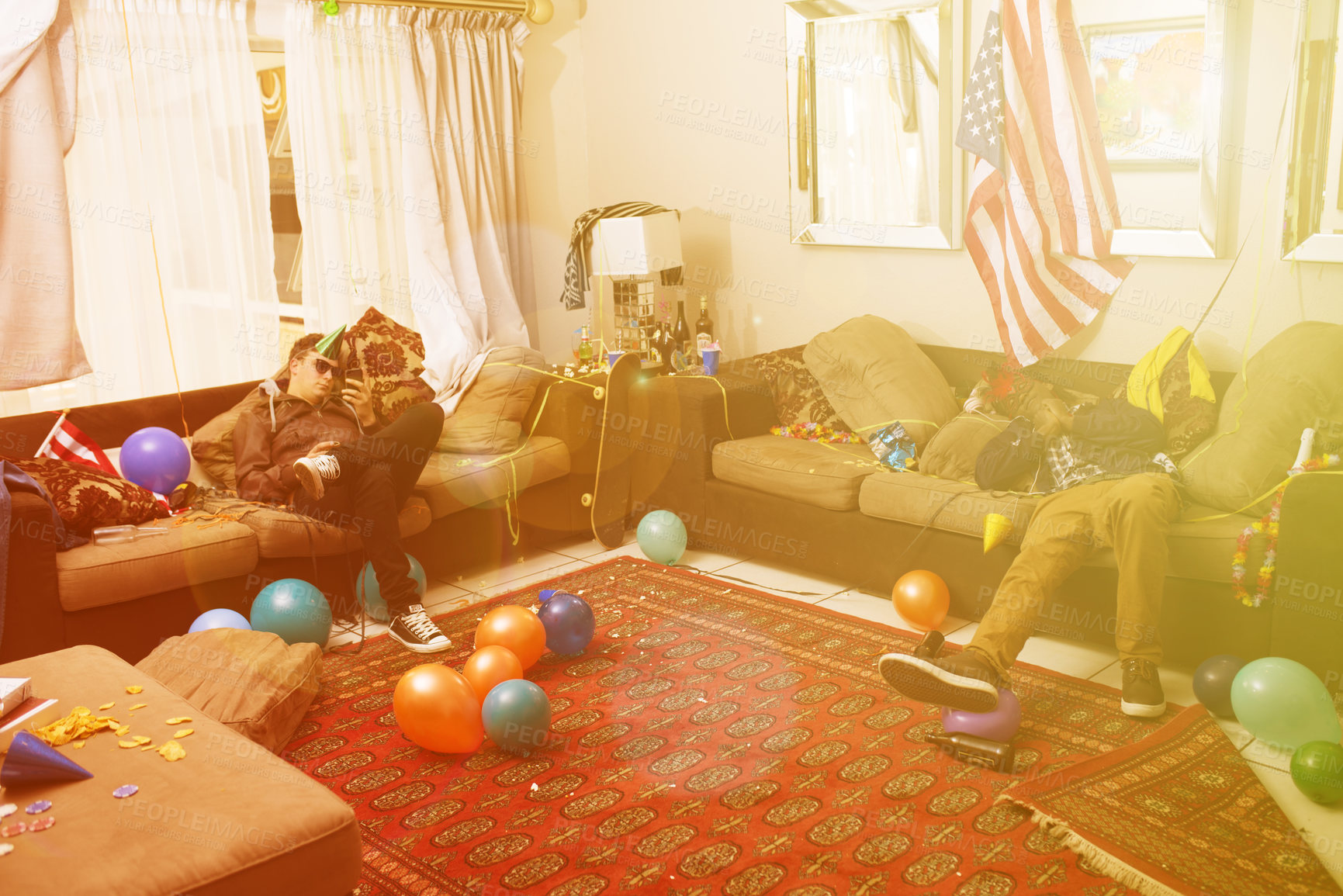 Buy stock photo Party, drunk and hangover with a man friends sleeping on a sofa in the living room of a home after a celebration. Birthday, social and alcohol with a male bachelor and friend passed out from drinking