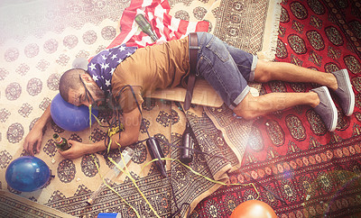 Buy stock photo Party, drunk and sleeping man after new years, social or drinking holiday event on a home carpet. Alcohol, celebrate and hangover of a tired person holding a beer bottle drink with addiction problem