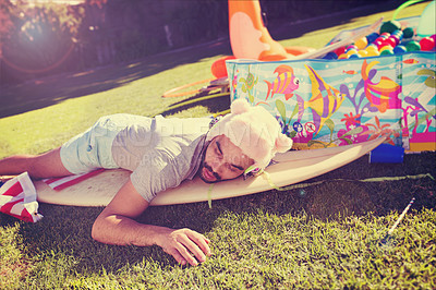 Buy stock photo Drunk man, sleeping and lawn in summer while passed out, drinking or hangover on surfboard in backyard. Party guy, asleep or tired from alcohol, cocktail celebration or sleep on grass in home garden
