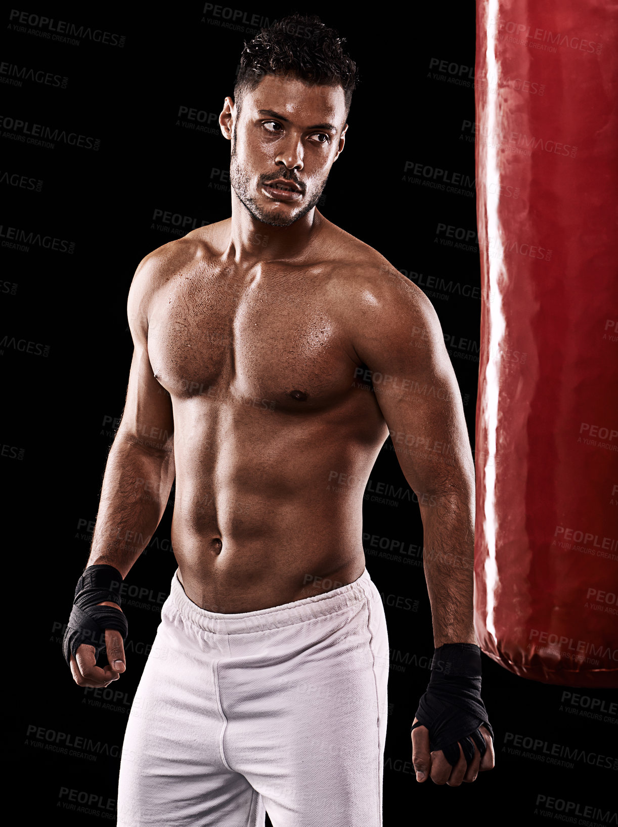 Buy stock photo Punching bag, man and boxing with fitness, training for a competition and wellness on a dark studio background. Person, model and guy with exercise and strong with workout and muscular with cardio