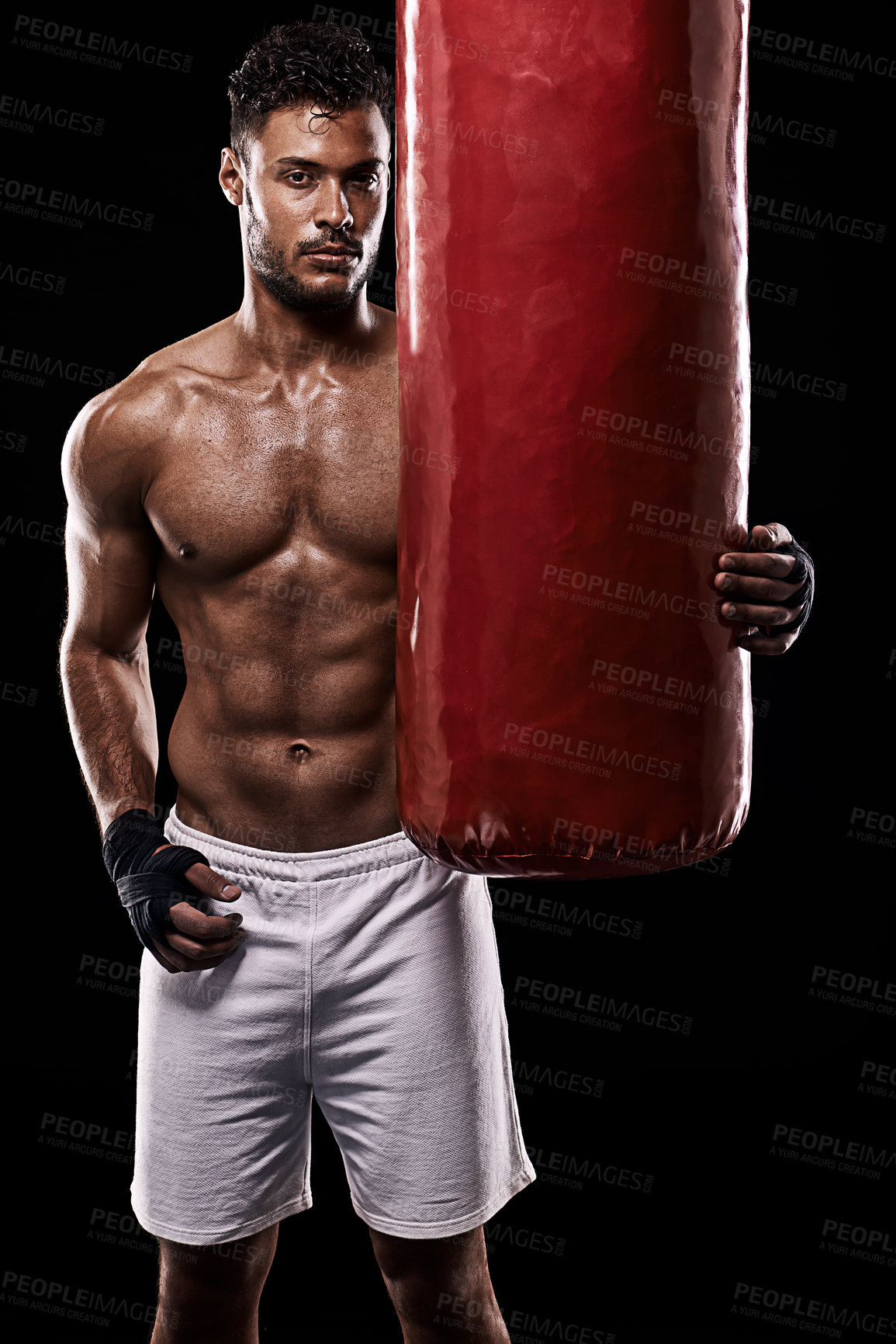 Buy stock photo Portrait, body and fitness man with punching bag in studio for training, challenge or power performance on black background. Face, chest and male fighter at gym for wellness, resilience or workout