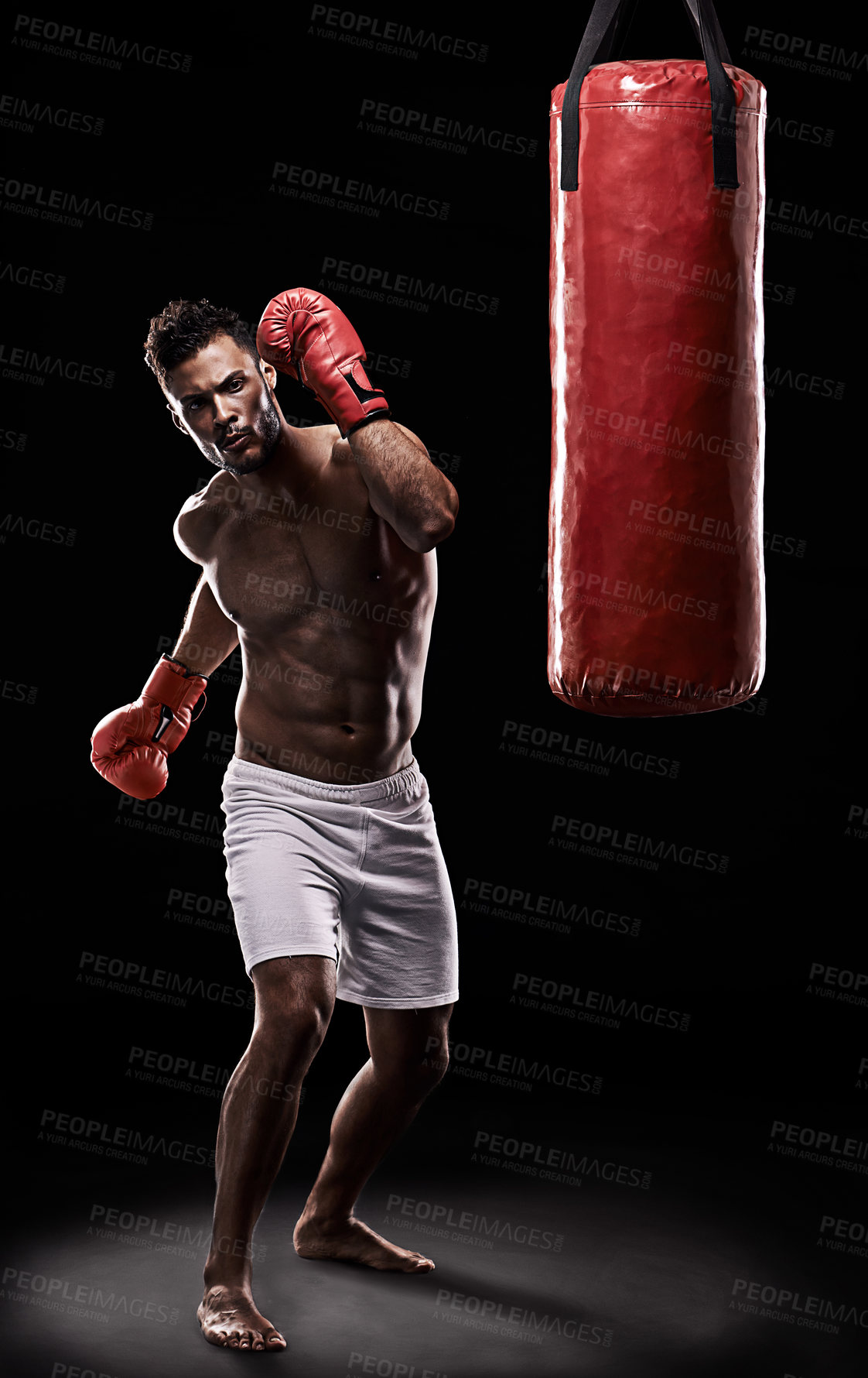 Buy stock photo Boxing, man and training in studio with punching bag for workout, exercise or competition fight with fitness. Athlete, boxer and confidence for martial arts with energy or topless on black background