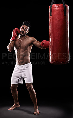 Buy stock photo Studio, athlete and man with punching bag and gloves for training with strength and muscle. Adult, boxer and male person in dark background, healthy and power with body for sport and serious for job