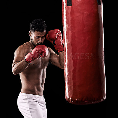 Buy stock photo Workout, boxer and man in studio with punching bag for training with strength and muscle. Adult, athlete and male person in dark background, healthy and power with body, fitness and sport for job