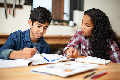 Buy stock photo Shot of two young students studying together in a classroom