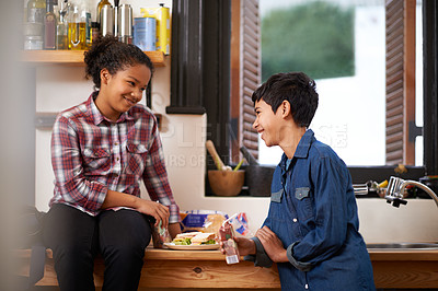 Buy stock photo Teenager, friends and eating food in kitchen for school holiday with bonding snacks for weekend, break or hungry. Girl, boy and smile for healthy nutrition in apartment for lunch, meal or connection