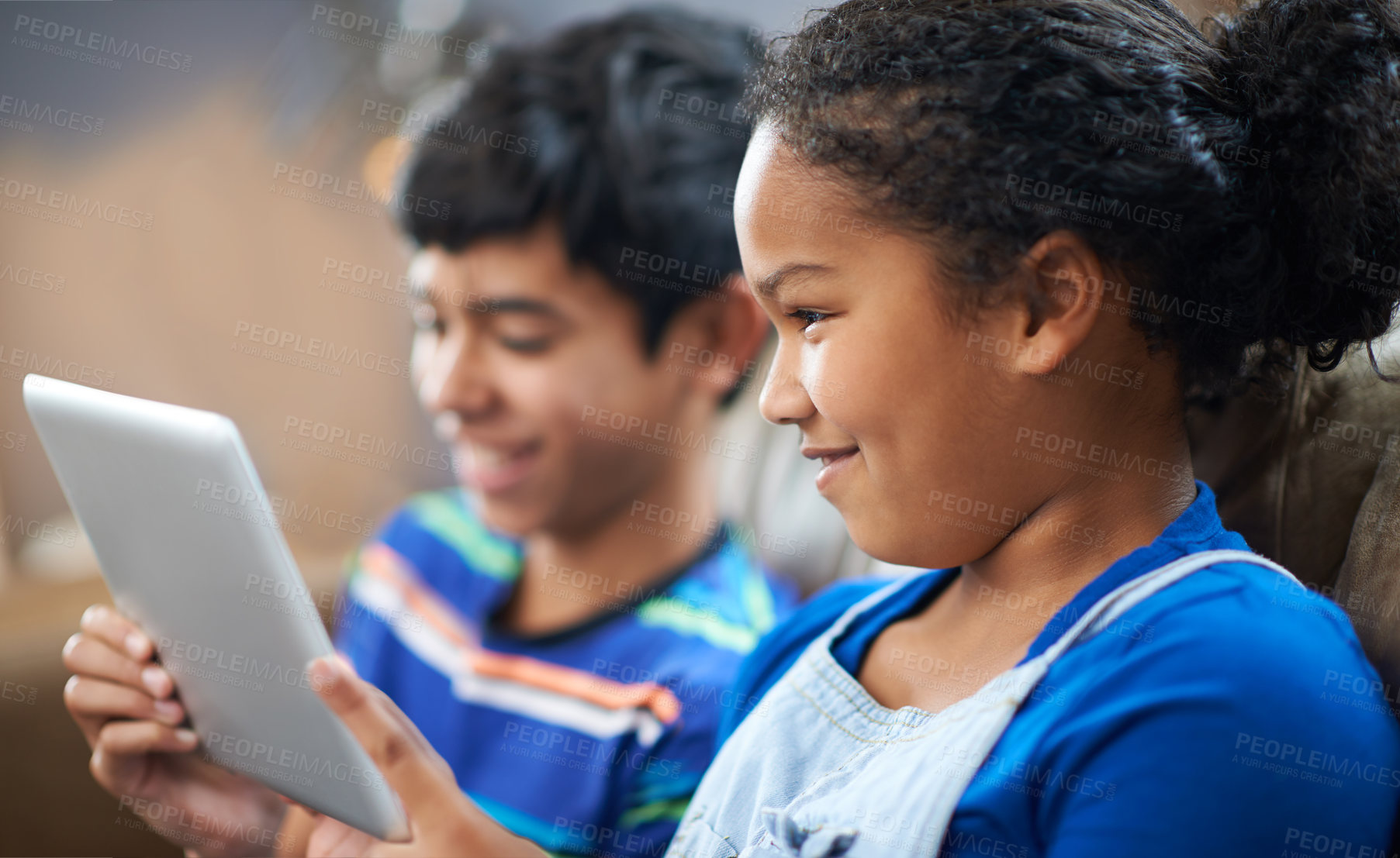 Buy stock photo Children, tablet and happy with smile on sofa, family home and technology for streaming and playing entertainment. Internet, siblings together and elearning for child development or online games