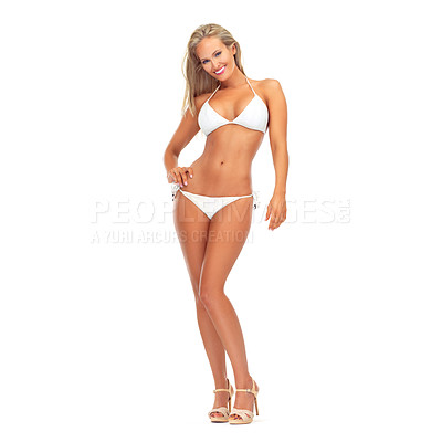 Buy stock photo Studio portrait of a sexy young woman smiling while posing in a bikini against a white background