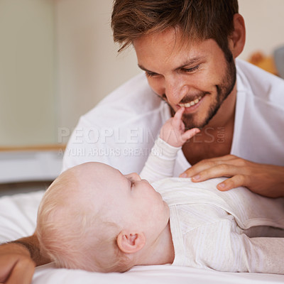 Buy stock photo Smile, sweet and baby with father on bed relaxing, playing and bonding together at home. Happy, love and young dad laying with girl child, infant or kid in bedroom or nursery at family house.