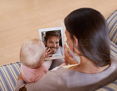 Buy stock photo Family, video call and mother with baby on digital tablet with father while bonding on a sofa in their home. Online, conversation and woman with kid on a couch, relax and content while speaking