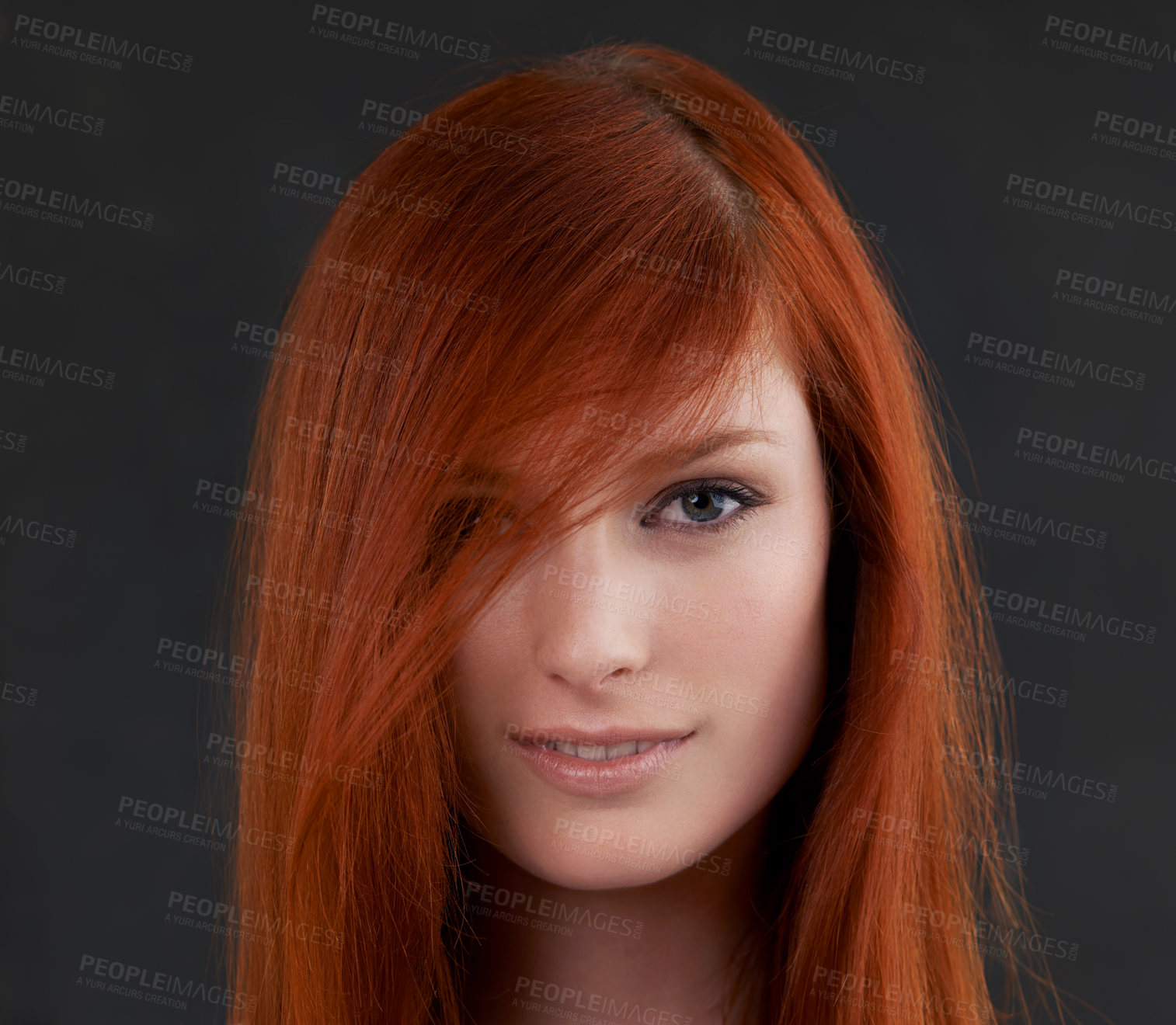 Buy stock photo Portrait of a gorgeous young redheaded woman against a black background