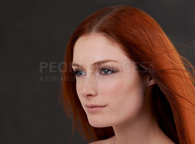 Buy stock photo Studio shot of a gorgeous young redheaded woman against a black background