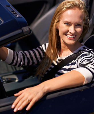 Buy stock photo Shot of a young woman driving in a sports car