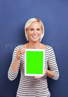 Buy stock photo Portrait, green screen and woman with a tablet, smile and connection on blue studio background. Face, person and mockup space with model and technology with connection and promotion with website info