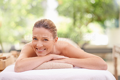 Buy stock photo Portrait, woman or bodycare in spa, wellness or beauty as relax, self care or zen in luxury retreat. Smile, glow or girl on massage table as mental health, cosmetology or natural makeup in balance