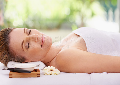 Buy stock photo Calm woman, sleeping and relaxing with towel for spa, zen or treatment on massage table, hotel or outdoor resort. Face of young female person asleep for peace, relaxation or accommodation in wellness