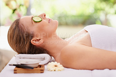 Buy stock photo Woman, relax and cucumber with towel at spa for facial treatment, care or peace at hotel or outdoor resort. Calm young female person in relaxation, zen or stress relief for natural beauty or skincare