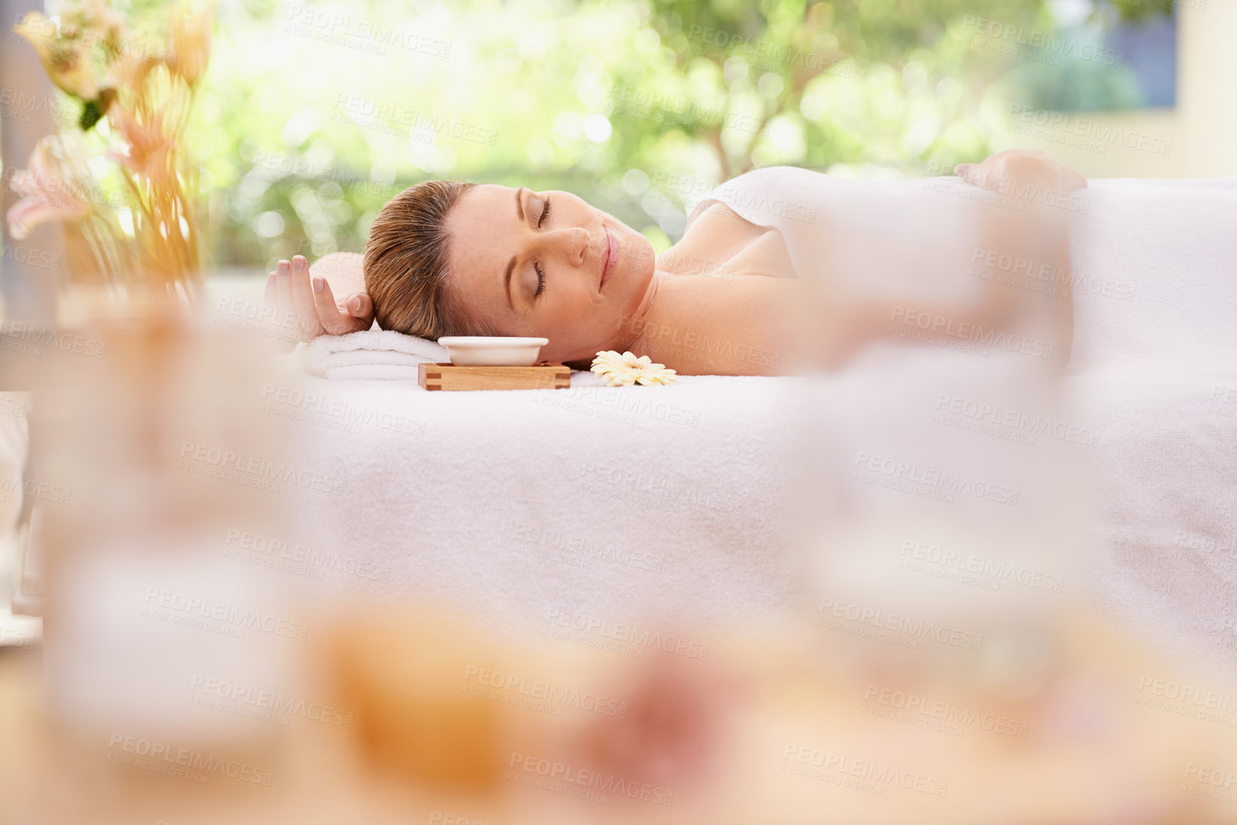 Buy stock photo Woman, relax and sleeping with towel at spa in stress relief, zen or health and wellness on massage table. Calm female person enjoying luxury skincare, body treatment or relaxation at peaceful resort