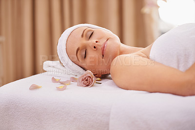 Buy stock photo Woman, spa and rest for zen, wellness and peace with relaxation and calm. Lady, towel and massage table at resort, lounge or luxury parlor with rose for holistic body and skincare for detox and break
