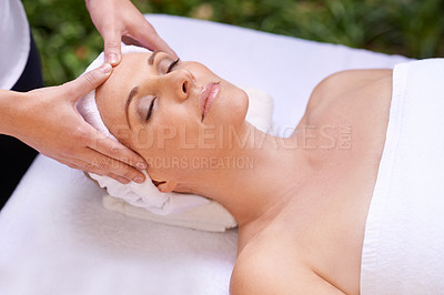 Buy stock photo Cropped shot of a woman in a day spa relaxing on a massage table