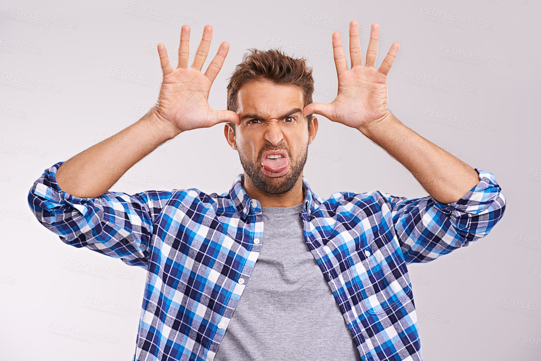 Buy stock photo Man, portrait and funny face in studio for goofy humor on white background for good mood, expression or mockup space. Male person, hands and tongue out with gesture for comedy joke, tease or playing