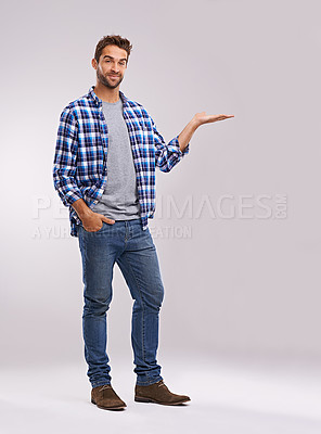 Buy stock photo Portrait, presentation and casual man in studio with smile, deal announcement and product placement. Showing, advice and creative person pointing at offer, notification and white background mockup