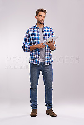 Buy stock photo Typing, tablet or man with connection, thinking or digital app on a grey studio background with social media, network or website. Person, mockup space or model with tech, opportunity or communication